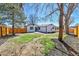 The backyard of this home boasts a wood fence, mature trees, and a patio at 10431 Holland St, Broomfield, CO 80021