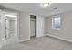 Bedroom featuring neutral paint, carpet, sliding closet doors and a window at 10431 Holland St, Broomfield, CO 80021