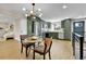 Eat-in kitchen with stainless appliances, lots of cabinetry, and open to living space at 10431 Holland St, Broomfield, CO 80021