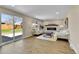 Bright living room with a cozy fireplace, modern furniture, and sliding door to patio at 10431 Holland St, Broomfield, CO 80021