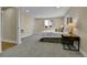 Spacious main bedroom featuring neutral decor, carpet flooring, and ensuite bathroom access at 10431 Holland St, Broomfield, CO 80021