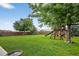 Expansive backyard with mature trees and an outdoor play structure at 425 Peabody St, Castle Rock, CO 80104