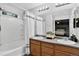 Bright bathroom with dual sinks, wood-finish vanity, and a shower-tub combo, providing a functional and stylish space at 425 Peabody St, Castle Rock, CO 80104
