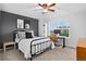 Comfortable bedroom featuring a dark accent wall, a stylish bed frame, and a dedicated workspace by the window at 425 Peabody St, Castle Rock, CO 80104