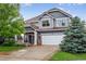 Charming two-story home with manicured lawn, mature trees, and a welcoming front porch at 425 Peabody St, Castle Rock, CO 80104