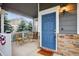 Inviting front porch with a blue door and stylish stone accents at 425 Peabody St, Castle Rock, CO 80104