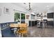 Bright kitchen featuring dark cabinets, stainless steel appliances, and tile flooring adjacent to an eat-in dining area at 425 Peabody St, Castle Rock, CO 80104