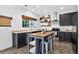 Contemporary kitchen showcasing dark cabinetry, a wooden island, and stainless steel appliances under recessed lighting at 425 Peabody St, Castle Rock, CO 80104