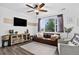 Cozy living room with a leather couch, large window, and stylish decor at 425 Peabody St, Castle Rock, CO 80104