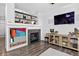 Bright and open living room featuring a fireplace and modern entertainment center at 425 Peabody St, Castle Rock, CO 80104