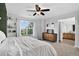 Spacious main bedroom with large windows, neutral carpet, view into the ensuite bath and plenty of storage at 425 Peabody St, Castle Rock, CO 80104
