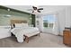 Serene main bedroom featuring a large window, soft carpet, and ample natural light, with an accent-colored green wall at 425 Peabody St, Castle Rock, CO 80104