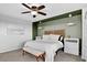Relaxing main bedroom with accent-colored green wall, a plush bed, soft lighting, and a comfortable bench seat at 425 Peabody St, Castle Rock, CO 80104