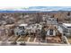 Aerial view of modern homes and mature trees with the Rocky Mountains in the distance on a sunny day at 2723 Grove St, Denver, CO 80211