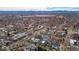 Wide aerial view of a neighborhood with a lake in the distance and the Rocky Mountains in the background at 2723 Grove St, Denver, CO 80211