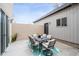 Cozy backyard patio featuring an outdoor dining set on a vibrant patterned rug, perfect for entertaining at 2723 Grove St, Denver, CO 80211