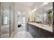 Bright bathroom with modern vanity, double sinks, walk-in shower, and an adjacent bedroom at 2723 Grove St, Denver, CO 80211