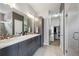 Contemporary bathroom features double sinks, modern vanity, and access to a walk-in closet at 2723 Grove St, Denver, CO 80211