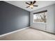 Neutral bedroom with a ceiling fan and a large window providing plenty of natural light at 2723 Grove St, Denver, CO 80211