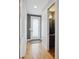 Hallway with hardwood floors leading to a modern powder room at 2723 Grove St, Denver, CO 80211
