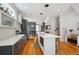 Modern kitchen with an island, open layout, stainless steel appliances, and a view into dining area at 2723 Grove St, Denver, CO 80211