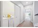 Convenient laundry room with washer, dryer, and ample storage space, located near hallway at 2723 Grove St, Denver, CO 80211