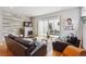 Cozy living room with fireplace, hardwood floors, and a sliding glass door to an outdoor patio at 2723 Grove St, Denver, CO 80211