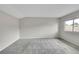 Spacious bedroom features soft carpeting, neutral paint, and a window offering ample natural light at 3890 S Atchison Way # B, Aurora, CO 80014