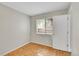 Minimalist bedroom with modern window, wood-look flooring, and natural light at 3890 S Atchison Way # B, Aurora, CO 80014