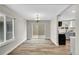 Open dining area featuring modern chandelier and access to the kitchen and patio at 3890 S Atchison Way # B, Aurora, CO 80014