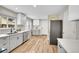 Well-lit kitchen with stainless steel appliances, gray cabinets, and light wood flooring at 3890 S Atchison Way # B, Aurora, CO 80014