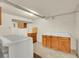 Laundry room featuring wooden cabinets, concrete flooring, and modern laundry appliances at 3890 S Atchison Way # B, Aurora, CO 80014