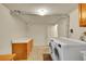 Well-equipped laundry room featuring a washer, dryer, storage, and functional space at 3890 S Atchison Way # B, Aurora, CO 80014