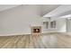Living room with a stone fireplace, wood flooring, and natural light through two windows at 3890 S Atchison Way # B, Aurora, CO 80014