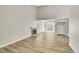 Open living space featuring wood floors, fireplace, and access to the patio at 3890 S Atchison Way # B, Aurora, CO 80014