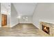 Open-concept living room boasting a fireplace, wood floors, and a high ceiling at 3890 S Atchison Way # B, Aurora, CO 80014