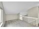 Bright loft area features neutral walls, carpeting, and white railings leading to additional spaces at 3890 S Atchison Way # B, Aurora, CO 80014