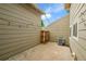 Outdoor patio area with an AC unit and a wooden gate at 3890 S Atchison Way # B, Aurora, CO 80014