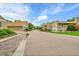 Street view featuring neutral-colored townhomes with well-maintained landscaping at 3890 S Atchison Way # B, Aurora, CO 80014