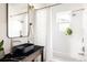 Modern bathroom featuring a black granite sink, sleek fixtures and a shower-tub combination with a white curtain at 4452 Stuart St, Denver, CO 80212