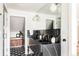 Elegant bathroom featuring double sinks with marble countertops and designer fixtures, complemented by stylish black and white flooring at 4452 Stuart St, Denver, CO 80212
