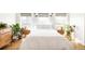 Bright bedroom featuring a bed, wood floors, bedside tables, plants, and three large windows for ample natural light at 4452 Stuart St, Denver, CO 80212