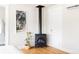 Cozy bedroom featuring a black wood burning stove, modern art and hardwood floors at 4452 Stuart St, Denver, CO 80212