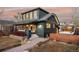 Stylish home boasts a covered porch, walkway, string lights, and meticulously landscaped yard at 4452 Stuart St, Denver, CO 80212