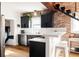 Modern kitchen with black cabinets, stainless steel appliances, and a breakfast bar at 4452 Stuart St, Denver, CO 80212