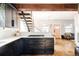 Contemporary kitchen showcasing dark cabinetry, quartz countertops, and hardwood floors at 4452 Stuart St, Denver, CO 80212