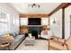 Inviting living room with a wood accent wall, fireplace, and comfortable seating at 4452 Stuart St, Denver, CO 80212