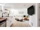 Bright living room with white sofa, modern furnishings, and a stylish wet bar area perfect for entertaining at 4452 Stuart St, Denver, CO 80212