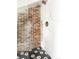 Modern shower featuring a brick wall, sleek fixtures, and elegant marble tiling for a luxurious feel at 4452 Stuart St, Denver, CO 80212