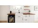Wet bar features custom wood counters, white cabinets, farmhouse sink and beverage fridge at 4452 Stuart St, Denver, CO 80212